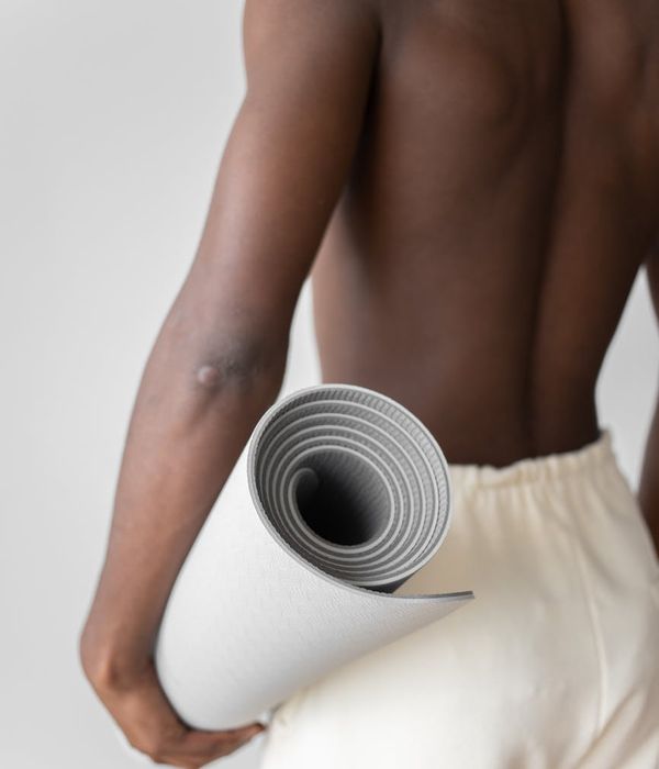 Man performing a core strength exercise in a bright, clean space.